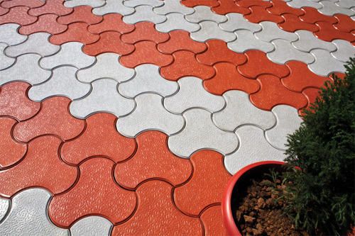 UCB Cobble Paver — red and white curved interlocking cobble-style concrete pavers by Unique Concrete Builders Kenya