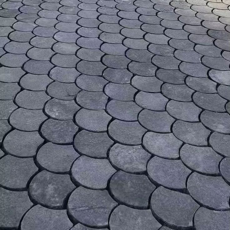 UCB Shell Paver — dark grey fish-scale shell-shaped interlocking concrete pavers arranged in a decorative pattern by Unique Concrete Builders Kenya