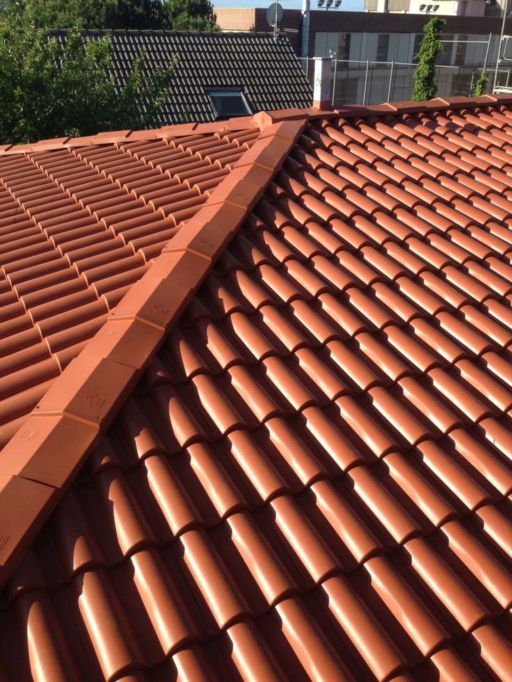 terracotta Portuguese barrel-style clay roof tiles on a rooftop by Unique Concrete Builders Kenya