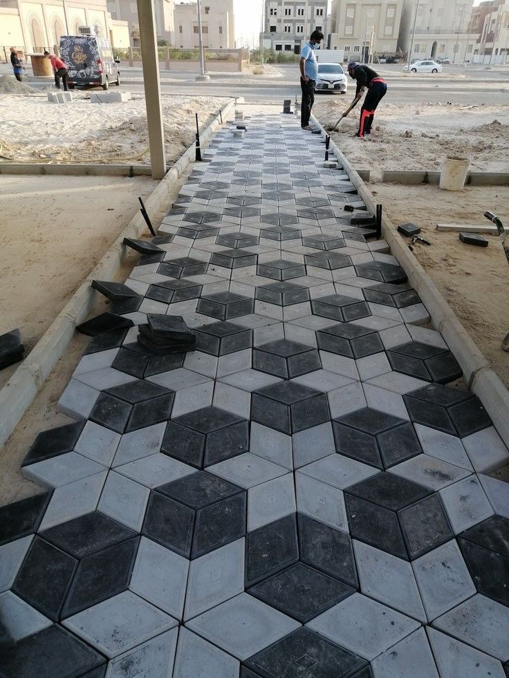 UCB Hexagon 3D Paver — grey and black three-dimensional optical cube hexagonal concrete pavers being installed on a driveway by Unique Concrete Builders Kenya