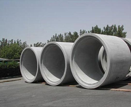 UCB 900mm Concrete Culvert — three large precast concrete culvert rings stacked outdoors at a production yard by Unique Concrete Builders Kenya