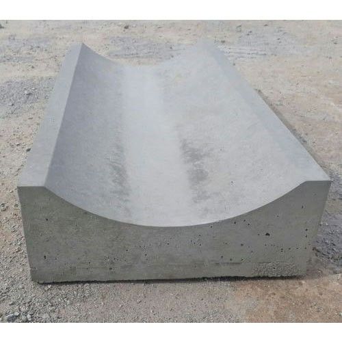 UCB Shallow Drain — single grey precast concrete shallow drain channel unit placed on gravel ground by Unique Concrete Builders Kenya