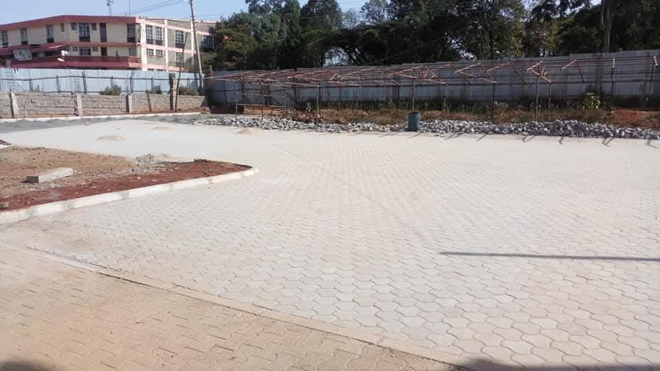 UCB Hexagon Pavers installed in a large parking compound in Kenya — classic hexagonal interlocking concrete paving pattern by Unique Concrete Builders