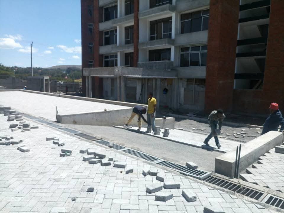 UCB Shallow Drain installed alongside a large commercial paving project in Kenya — surface water management with Uni Pavers