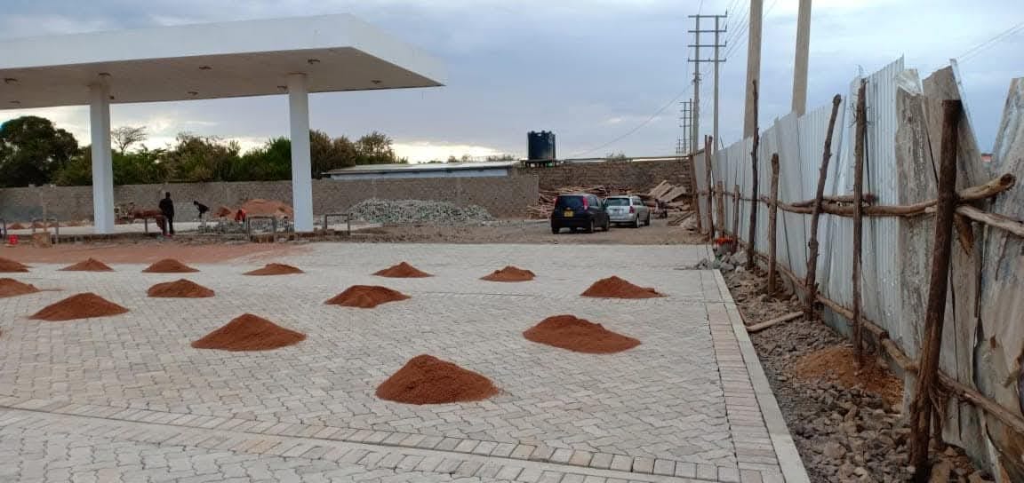 UCB Uni Paver forecourt installation at a petrol station in Kenya — interlocking concrete paving blocks laid across a fuel station forecourt by Unique Concrete Builders
