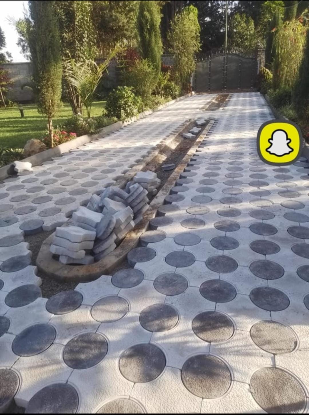 Grey and dark grey Round and Cross Pavers installed as a premium garden driveway in Kenya — UCB circular and cross interlocking concrete paving blocks by Unique Concrete Builders