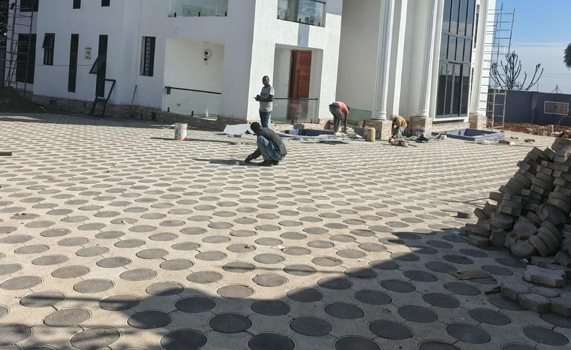 Large circular concrete pavers installed in a grid pattern on a premium mansion compound in Kenya — UCB interlocking paving by Unique Concrete Builders