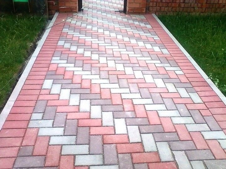 UCB Quad Paver — red, pink and white herringbone rectangular cabro concrete pavers laid on a driveway by Unique Concrete Builders Kenya